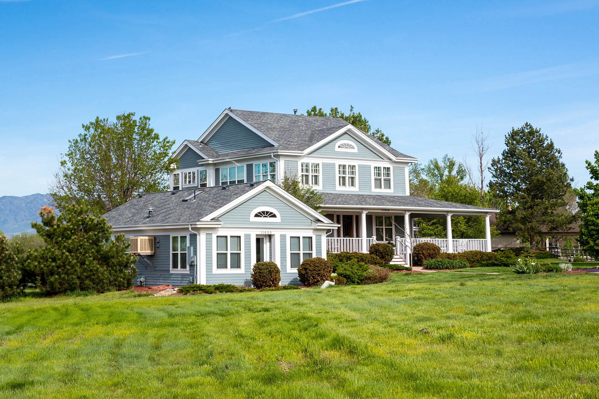 large, ranch style home with white window frames