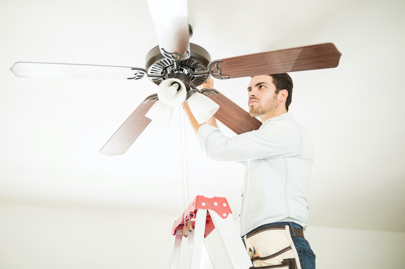 man fixing ceiling fan