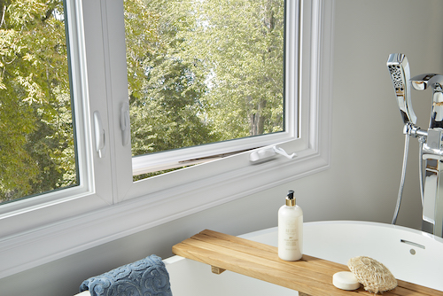 closeup of a bathroom tub with casement windows