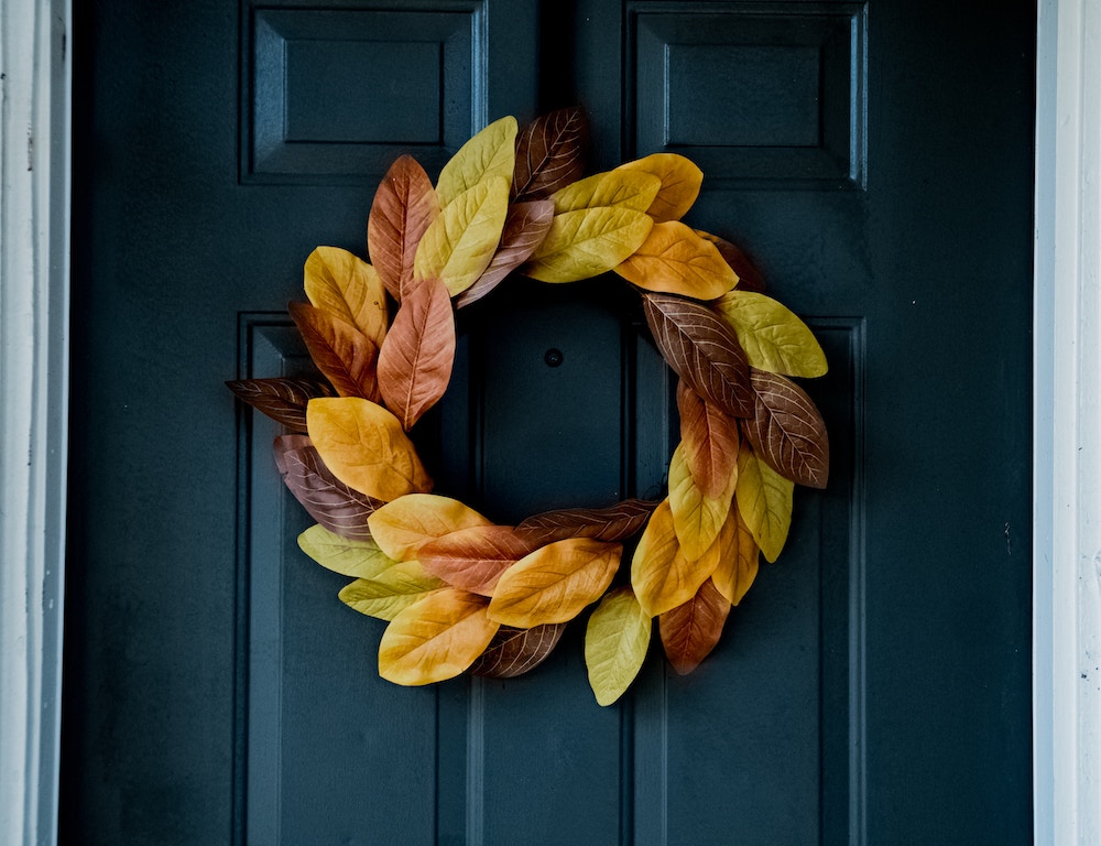 fall wreath on a black entry door